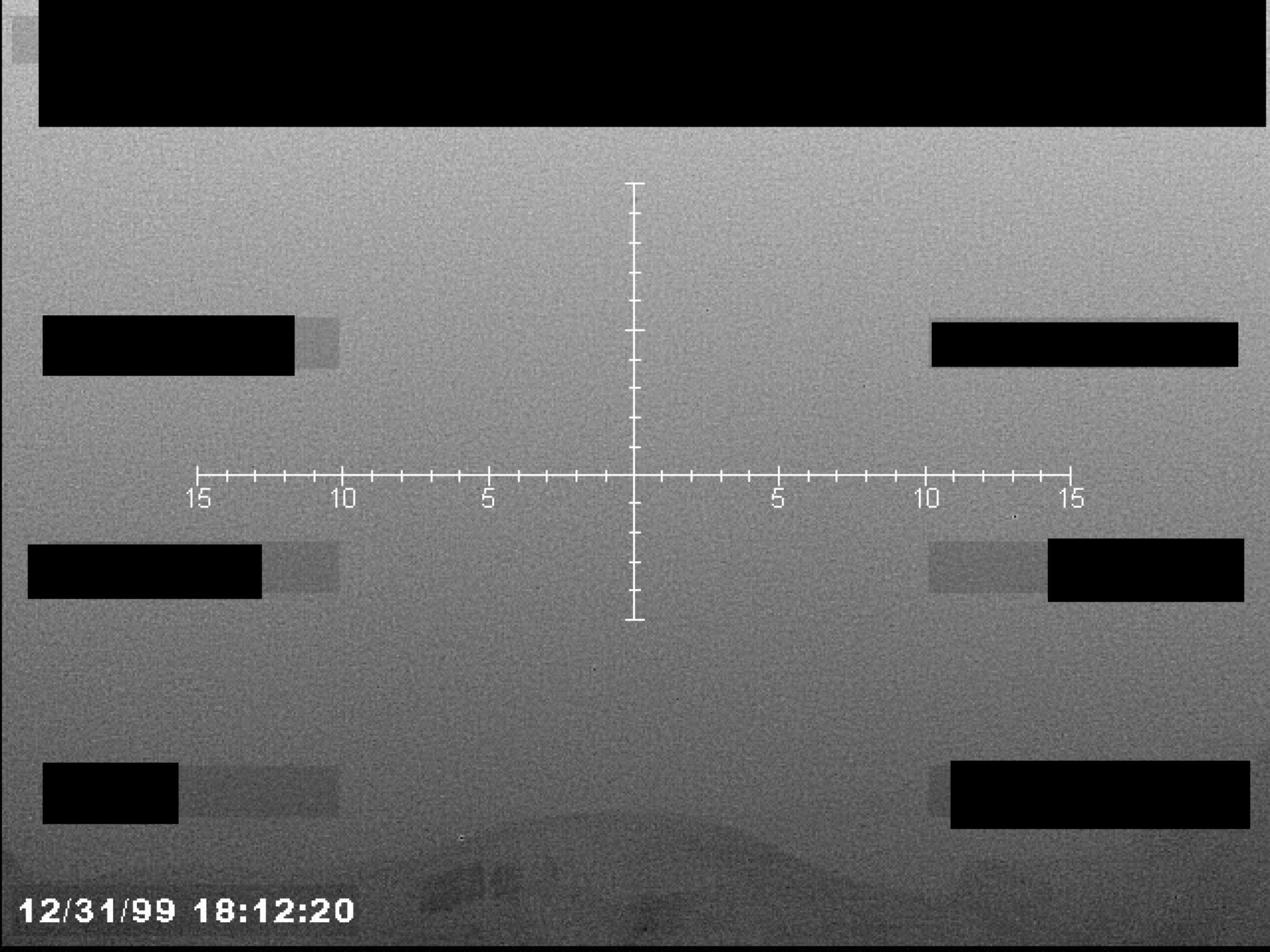 A sensor display, possibly infrared, showing a crosshair reticle with a numerical scale and a timestamp at the bottom left.