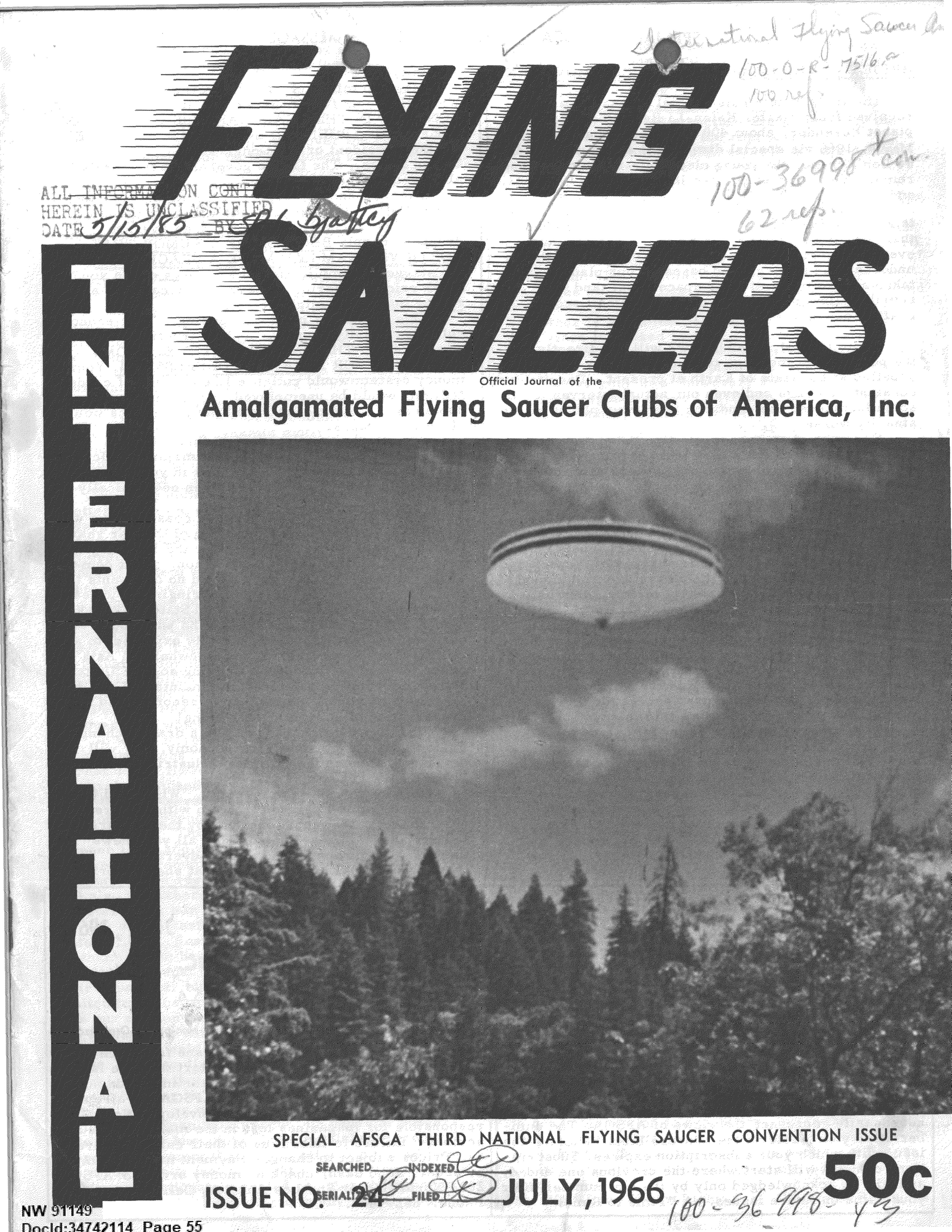 A photograph of a flying saucer hovering over a forested area.