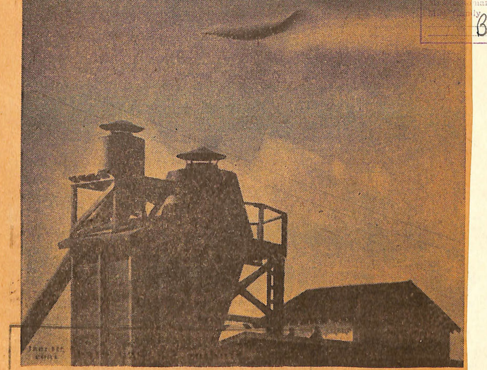 FLYING SAUCER MAYBE?-The unknown object over the building in the picture, photographed above Anacortes, moves swiftly through the sky, seemingly a part of a cloud formation. But is it? Walter Elliott of Anacortes was preparing to take a picture of the building when he noticed the unusual saucer-like object in his view finder, so he snapped the picture at 1/100th of a second. Elliott was unable to determine the nature of the unusual object which quickly disappeared. (Associated Press Wirephoto.)