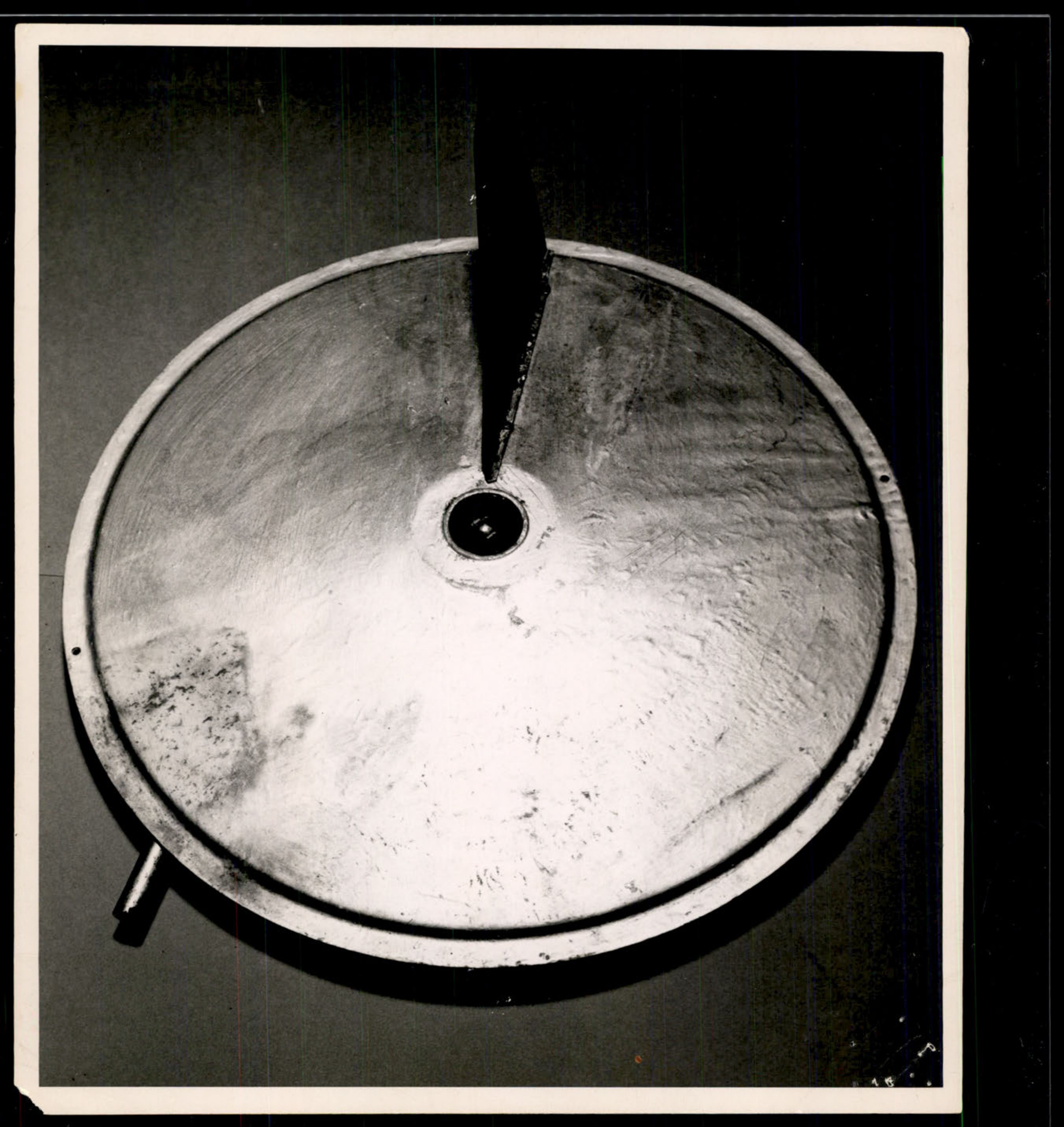 Photograph showing the bottom view of a circular, metallic object, likely the 'flying disc' recovered in North Hollywood, California.