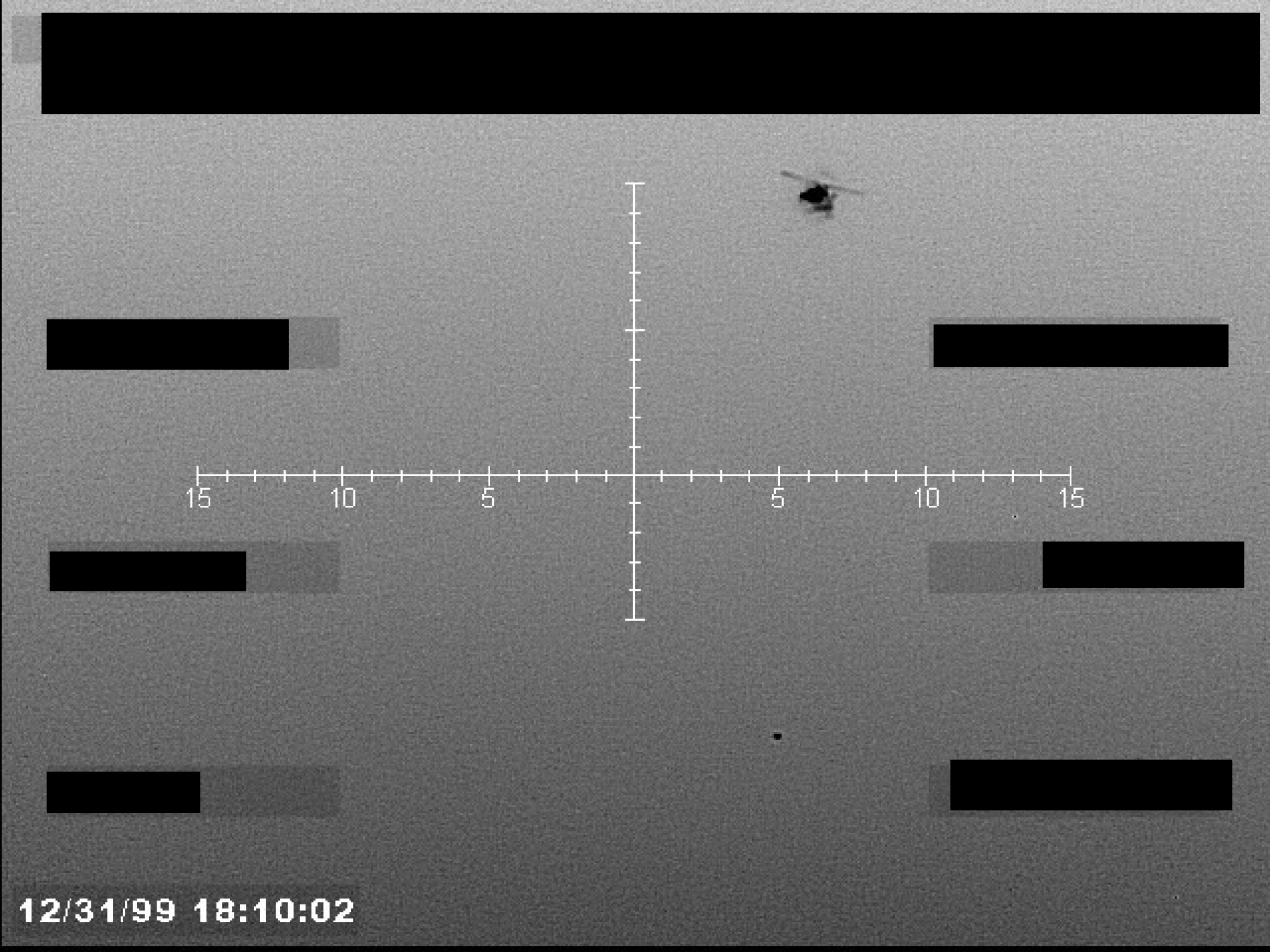 Grayscale sensor footage showing a central crosshair, a small object in the upper right, and a timestamp in the lower left. Several data fields are redacted.