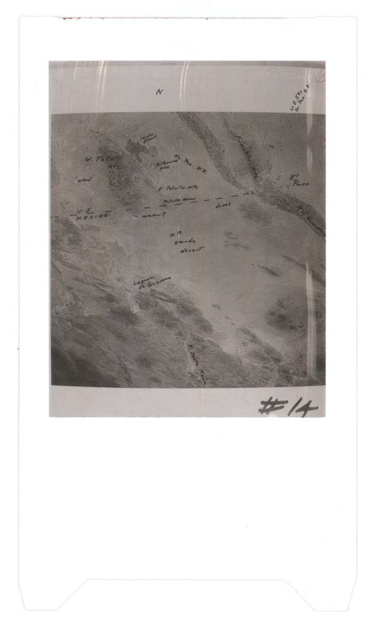 Aerial photograph with handwritten annotations including directional marker 'N', 'U.S. MEXICO' border notation, and various illegible handwritten notes; numbered '#14'