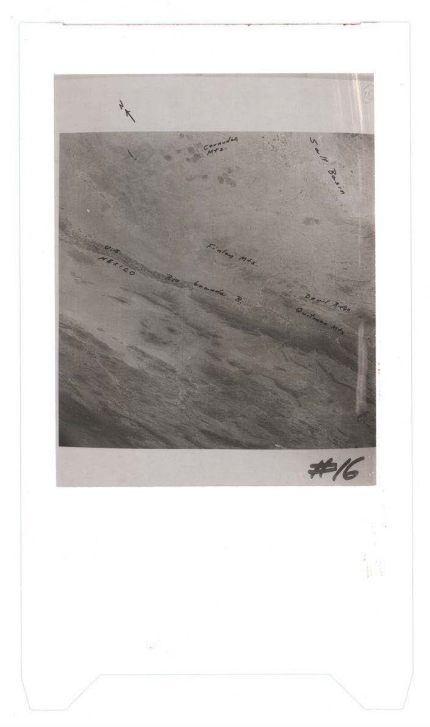 Aerial photograph showing terrain with handwritten annotations including location markers and what appears to be route or boundary markings