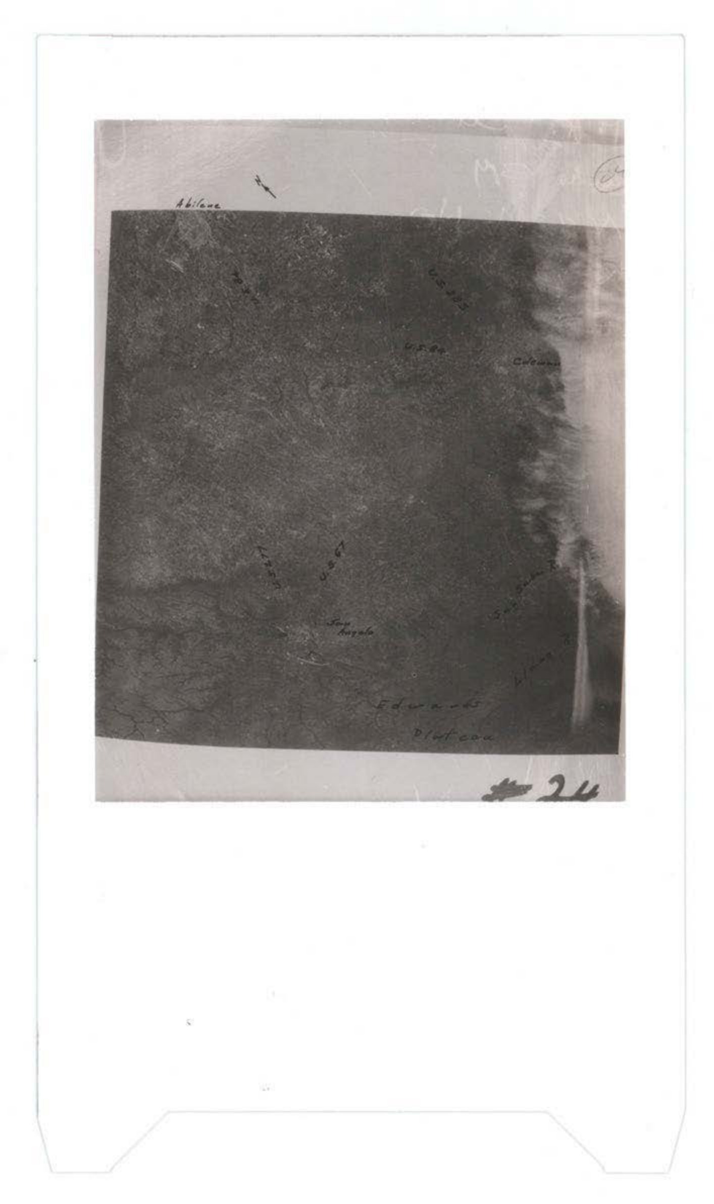 Aerial or ground photograph with handwritten annotations, appears to show terrain or debris field