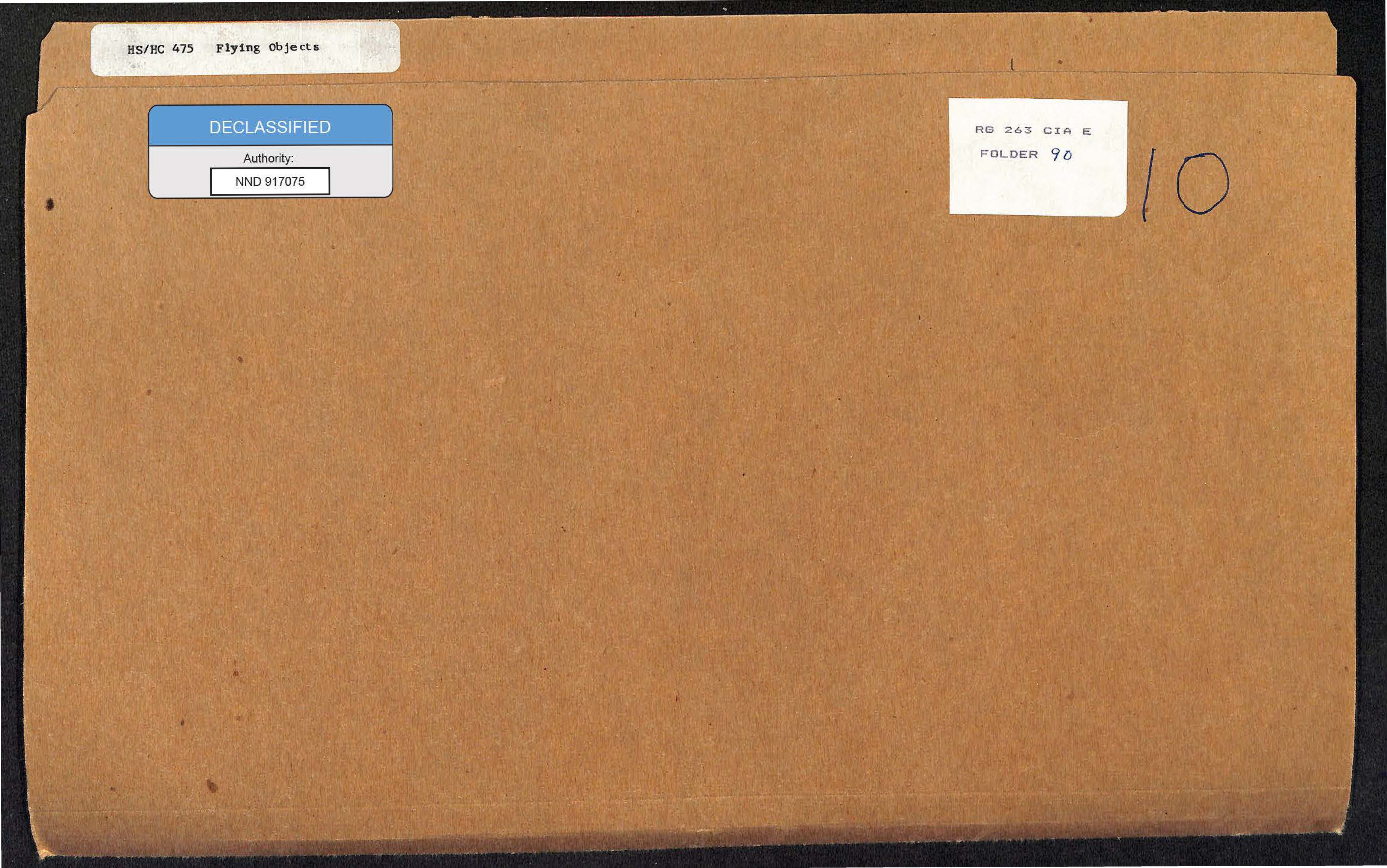 A photograph of a cardboard file folder with several labels.