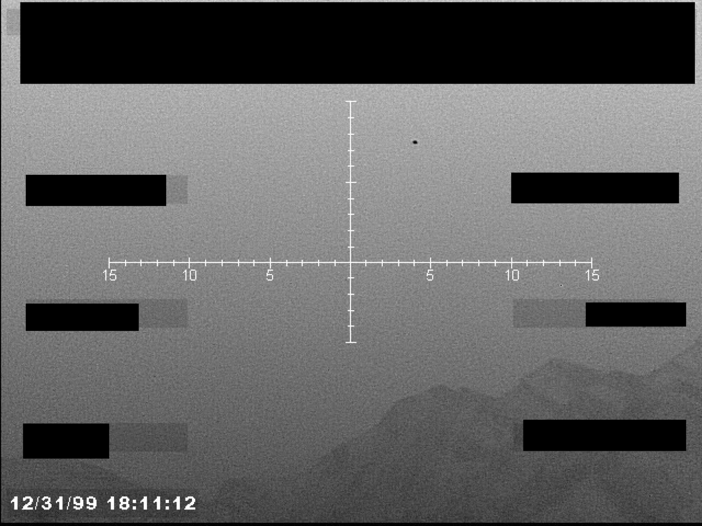 Sensor footage showing a reticle, a small dark object, and redacted data blocks over a grainy landscape.
