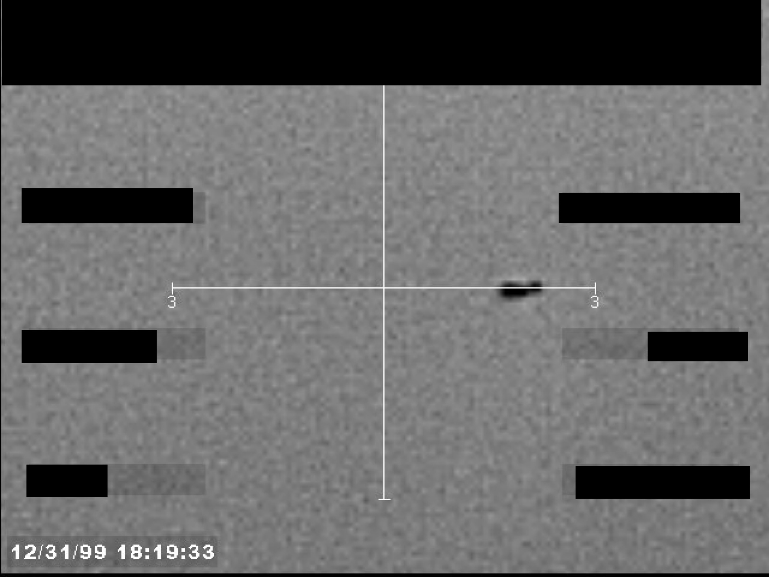 Sensor display showing a central crosshair and a small, dark, unidentified object. A timestamp '12/31/99 18:19:33' is visible in the bottom-left corner.